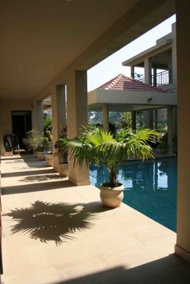 The swimming pool and planters seen from the porch