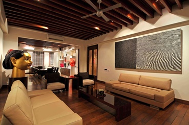 The living area with warm wooden interiors, and contemporary furniture.