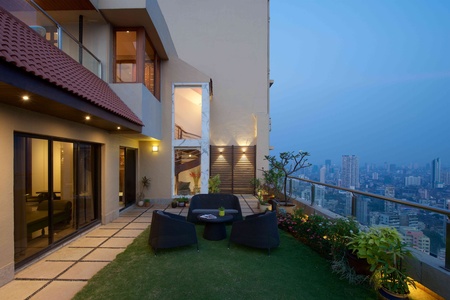 A backdrop at the far end of the terrace adds another dimension to the design scheme.