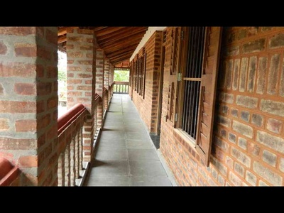 Exposed brick wall with mud pointing, and veranda laid with Tandoor Slabs