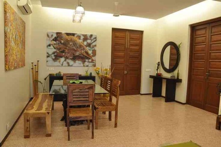 Dining Area With Wooden Furniture and painting.